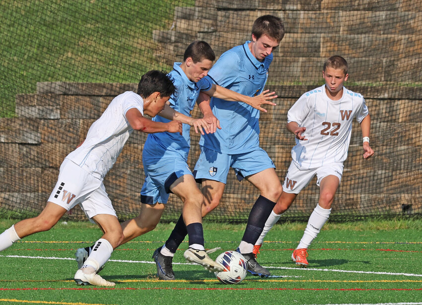 Flanked by two Westtown players, SCH seniors Andrew Laudenbach (with foot on ball) and Michael Glennon look to attack along the left endline.