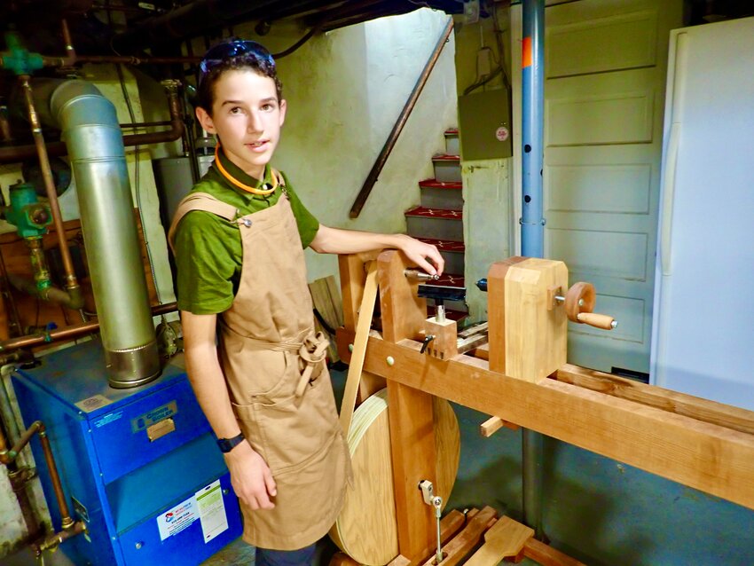 Mozi Weisenberg with the lathe, which he made from scratch, to craft other wooden products.