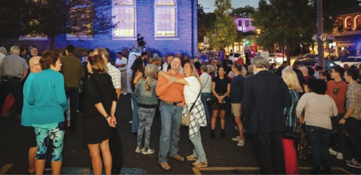 Residents watch as the Chestnut Hill Conservancy flips the switch, illuminating storefronts along Germantown Avenue for the organization's annual &quot;Night of Lights&quot; event.