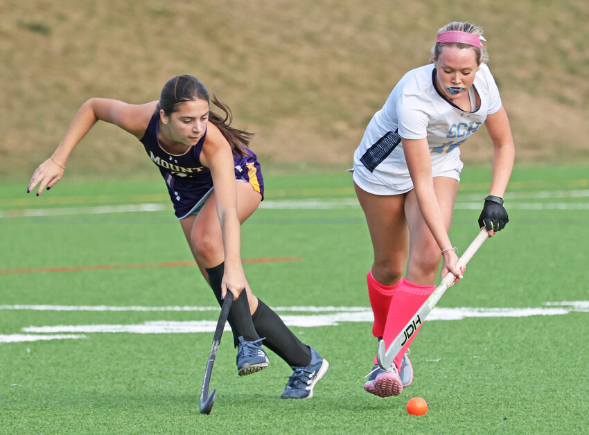 Blue Devils sophomore Amelia Clements (right) brings the ball through the midfield, shadowed by Mount junior Katie Tropiano.