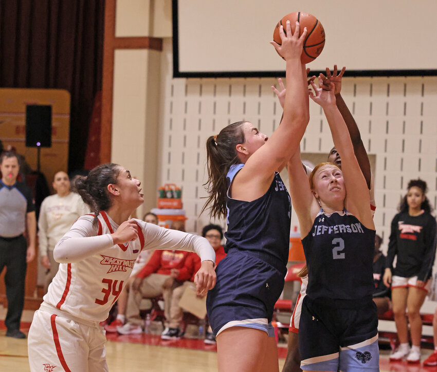 Jefferson's Cassie Murphy (center) goes up to grab a rebound between her teammate Tori Nigro (right) and Chestnut Hill's Bri Rider.