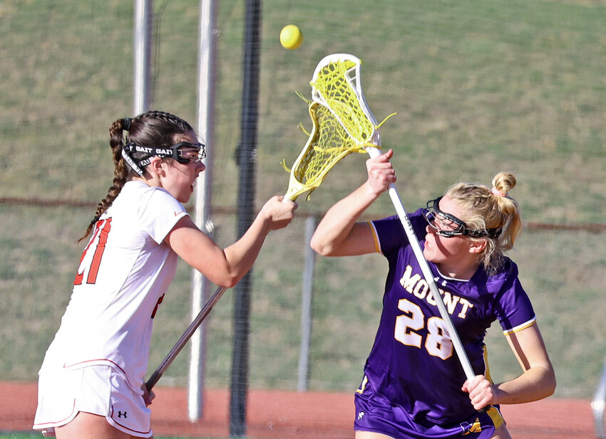 Mount St. Joe junior Gabby Clair takes a center draw with Gwynedd's Maddie Miller.
