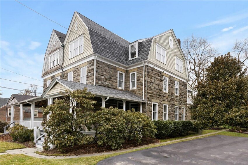 Classic Wissahickon schist and deep, shady porches grace the front of twin homes on West Highland Avenue.