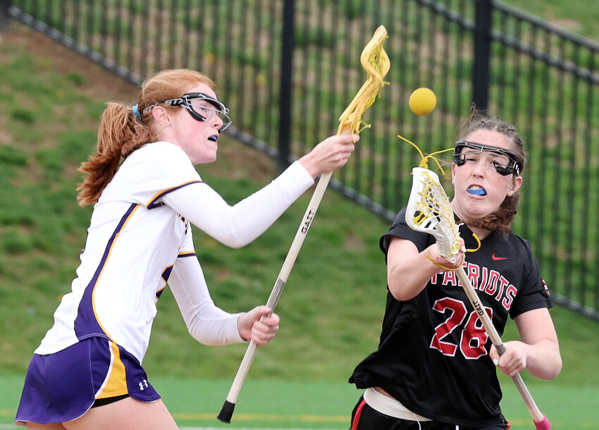 The ball is up for grabs during a center draw between the Mount's Emily Holmes (left) and GA's Lily Hart.