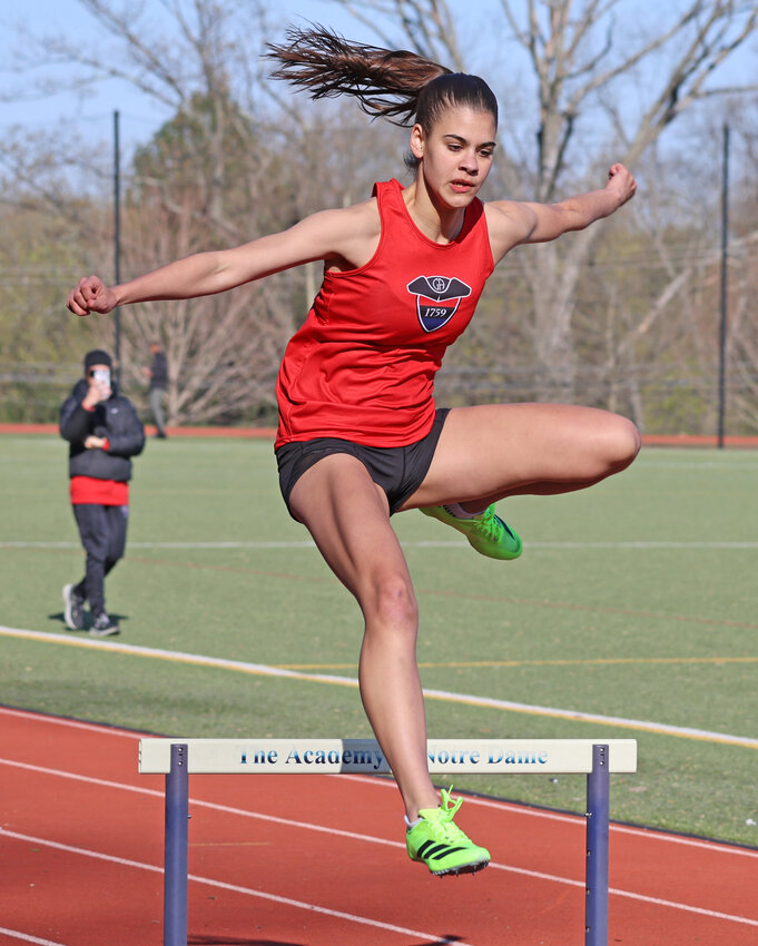 Sylvie Harrington, a GA junior, clears the second hurdle on her way to a win in the 300-meter hurdles.