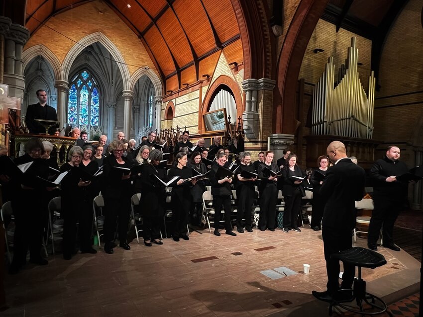 St. Martin-in-the-Fields Church director of music and arts Tyrone Whiting (foreground) leads singers from the congregation in collaboration with the choir at Christ Episcopal Church for a performance of &ldquo;The Crucifixion&rdquo; by John Stainer.