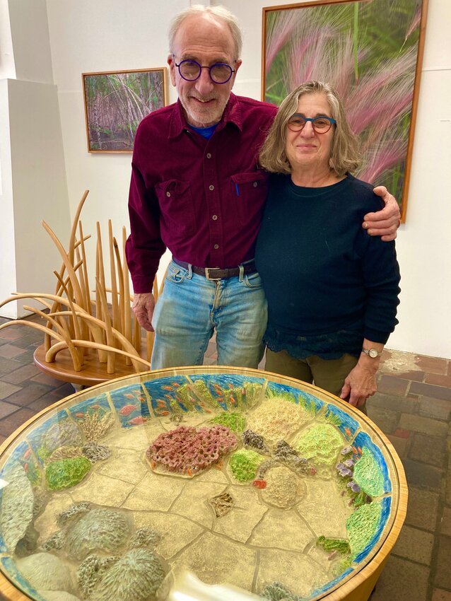 Peter Handler and Karen Singer with their collaborative &quot;Coral Reef Table,&quot; depicting bleached and dying coral.