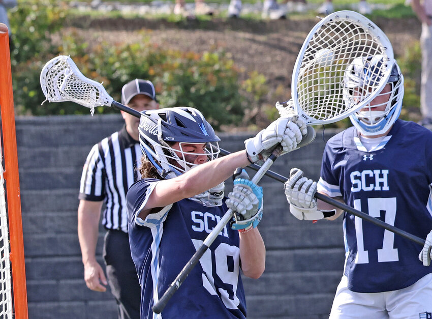 On a Haverford shot, the ball passes outside the stick of SCH sophomore goalie Moe Sobel and veers wide to the right of the cage.