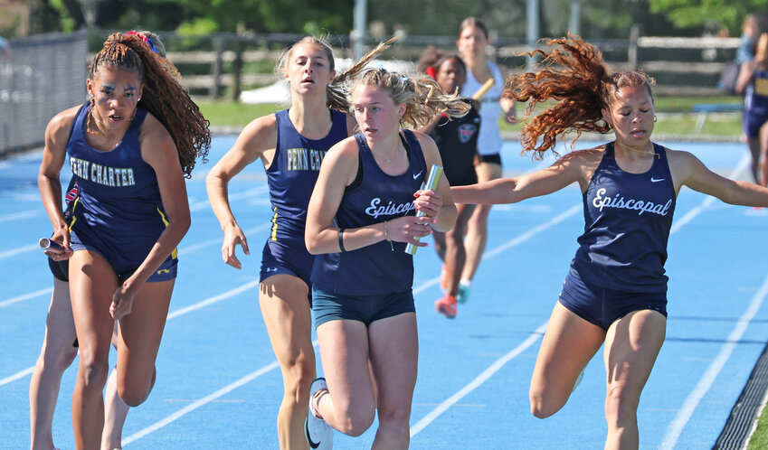 In the 4x400 relay, Penn Charter junior Michaela Polland (left) receives the baton from senior Alli DeLisi (center background) as Episcopal's Ava Cavanaugh gets the handoff from Ryann Newcomb (right). Polland and the Quakers won by a half second.