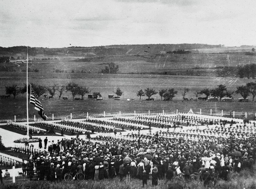 Hundreds of French people gather beneath the flag at half mast to pay tribute at the graves of the men who fought and died in Belleau Wood.