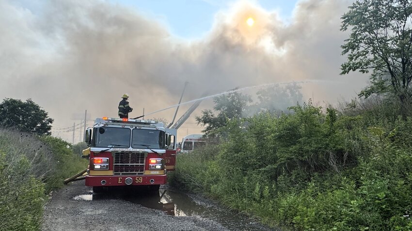 Firefighters battle the blaze at SEPTA&rsquo;s Midvale lot.