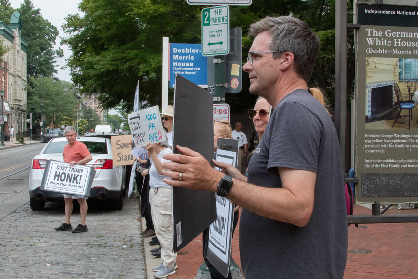 Protesters gather in front of the Germantown White House, at 5442 Germantown Ave., on June 13, in solidarity with the larger event happening on June 14.