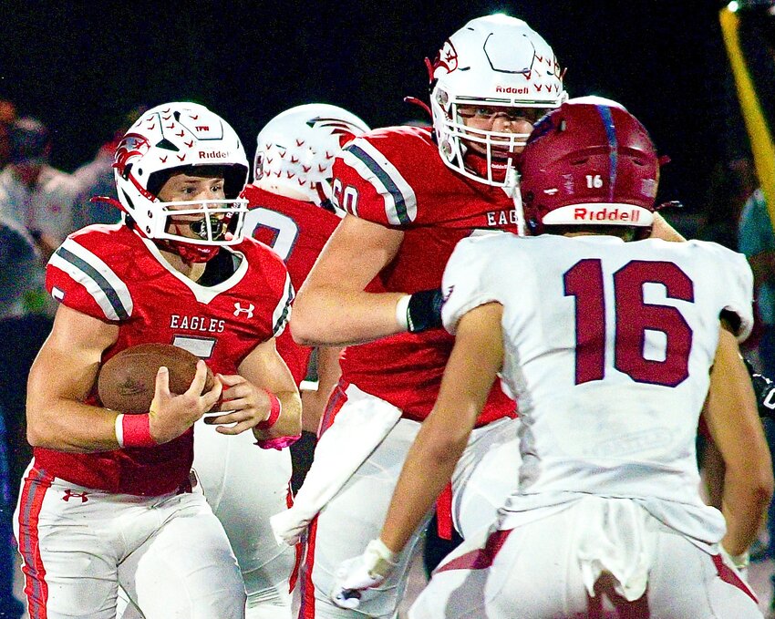 NIXA'S DYLAN REBURA follows blocking ahead of him by Hunter Jensen versus Joplin on Friday.