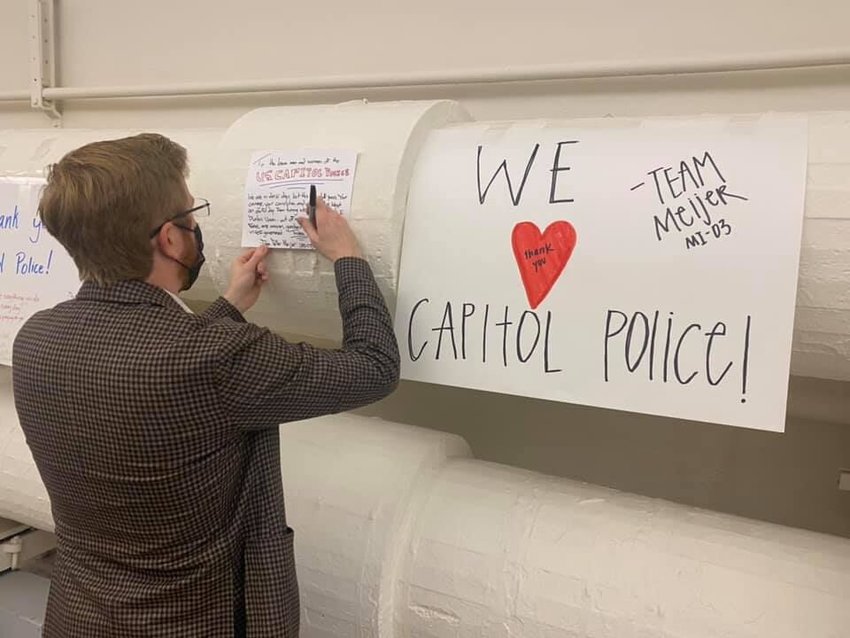 U.S. Rep. Peter Meijer, R-Michigan, signs his name to an appreciative poster for the Capitol Hill Police Department outside his office in Washington, D.C.