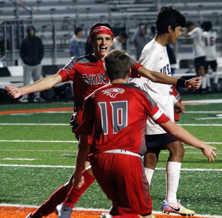 CARSON PALMER celebrates his game-winning goal with teammate Riley Lister following Nixa's 2-1 overtime triumph over Joplin in a Class 4 District 12 semifinal Monday.