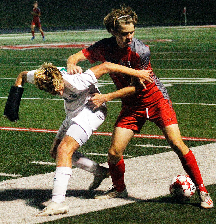 BRODY SANDERS battles a Catholic player for control of the ball Thursday.