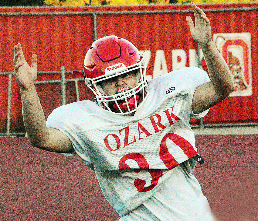 TYLR BOLIN signals for a touchdown after he crossed the goal-line on a 10-yard run during an Ozark scrimmage Monday.