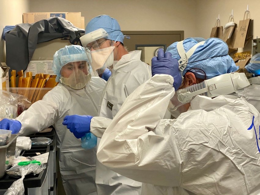 HEALTH WORKERS at Cox Medical Center South in Springfield don personal protecting equipment (PPE) in a &ldquo;donning room&rdquo; before they go to work on one of the hospital&rsquo;s units full of patients sick from COVID-19.