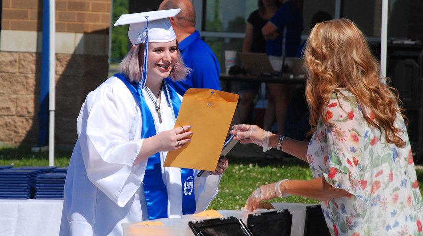 Megan Edwards graduates from Clever High School as part of an outdoor ceremony held in June 2020.