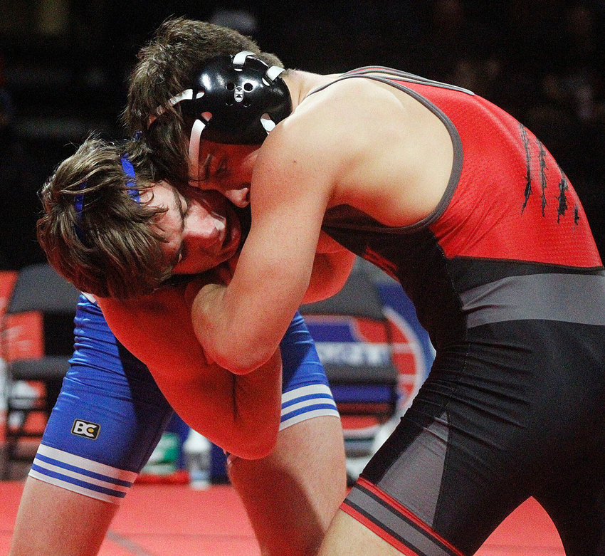 OZARK&rsquo;S BRAXTON STRICK battles Liberty&rsquo;s Kage Lenger in the 138-pound Class 4 championship match Saturday.