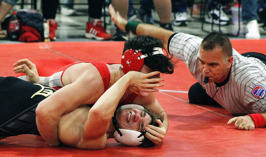 NIXA&rsquo;S COLE CRAHAN closes in on a pin at 170 pounds versus Farmington on Friday.
