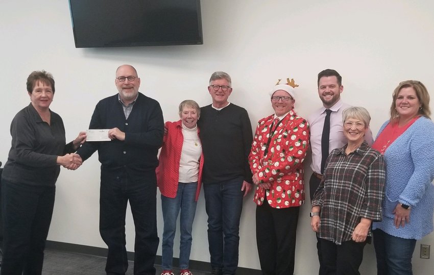 FINLEY RIVER COMMUNITY FOUNDATION (FRCF) BOARD MEMBER JANIS CREEK presented a check to Children's Smile Center executive director Jackie Barger in the amount of $2,102. Pictured, from left to right: Creek, Barger, and FRCF board members Elise Crain, Mike Woody, Gerald Chambers, John Hedgpeth, Jean Ann Hutchinson and Dana Murfin, at an FRCF board meeting December 21.