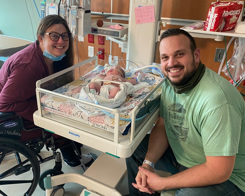 CLARA EVERDING (center) of Nixa was born at 12:38 a.m. on Jan. 1, 2022, to parents Kelly (left) and Nathan (right) Everding at Cox Medical Center South in Springfield.