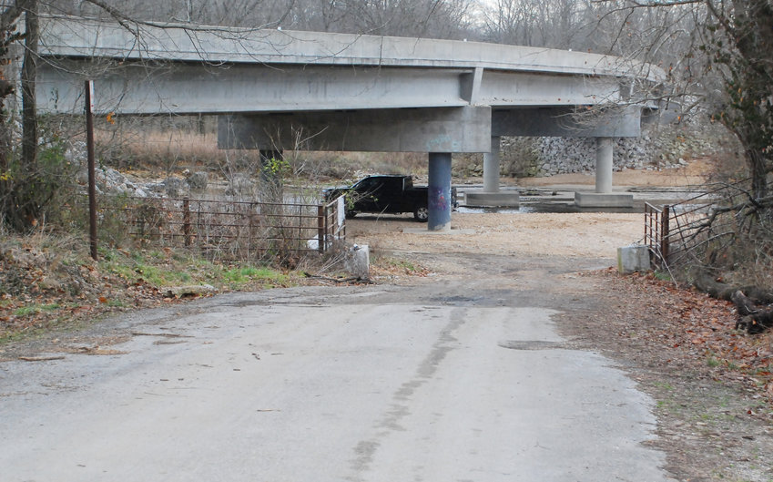 GATES AND CONCRETE BLOCKS at the end of the asphalt on Canyon Road have been moved aside, allowing vehicles to pass through and park in the gravel at Lindenlure near the Highway 125 bridge between Sparta and Rogersville.