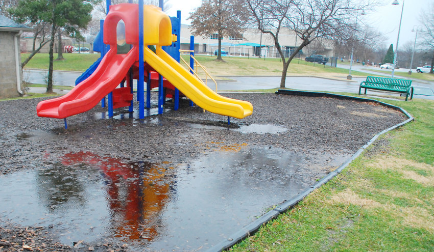 WATER COLLECTS on the south edge of the playground at McCauley Park in Nixa after a rain shower in December 2021.