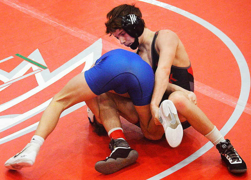 OZARK&rsquo;S CADEN HARRINGTON works his way toward a 7-5 overtime victory in a Class 4 District 3 quarterfinal match Friday.