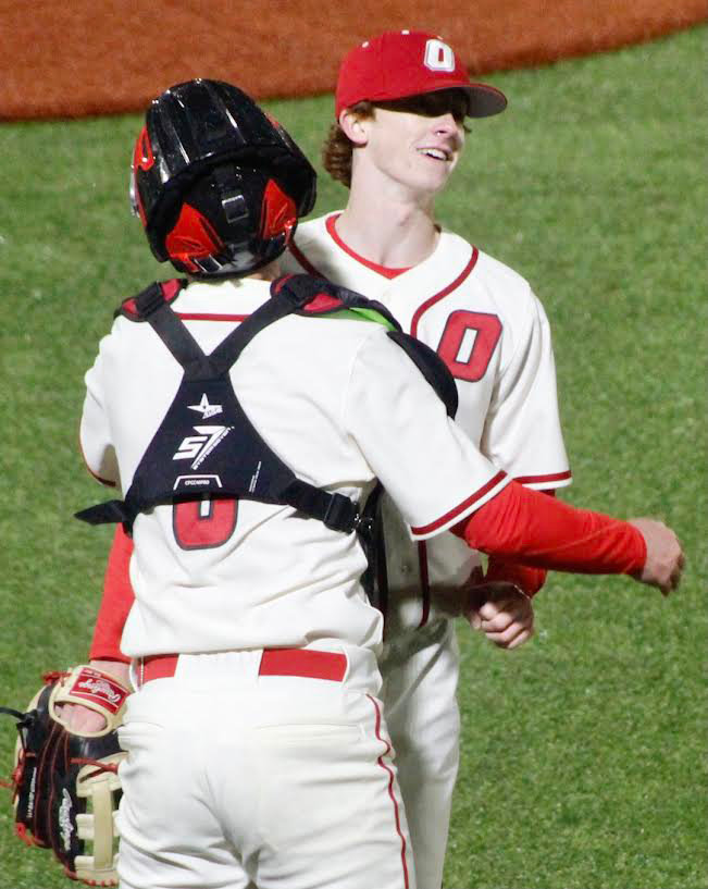 OZARK&rsquo;S DEVYN WRIGHT receives congrats from catcher Cooper Buvid after saving the Tigers&rsquo; 4-3 win Friday.