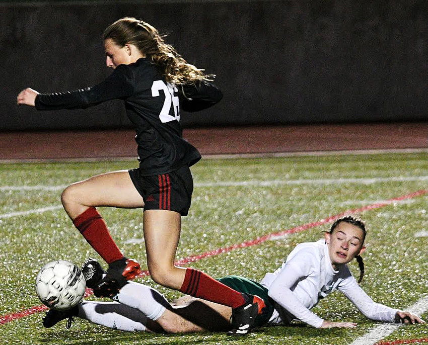OZARK&rsquo;S ADDIE SHULER gains control of the ball and breaks away from a Catholic player Monday.