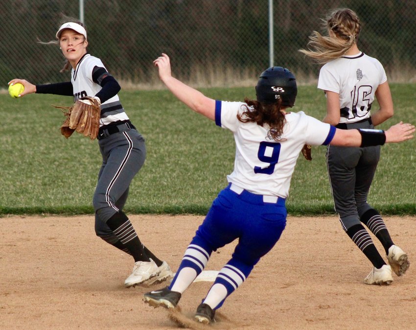 SPARTA'S MEGAN BROWN attempts to complete a double play as Clever's Lindy Twigg slides into second base in the teams' matchup Tuesday.