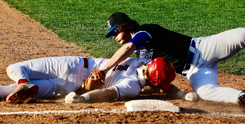 NIXA'S JARET NELSON is tagged out at third base against Hollister on Friday.