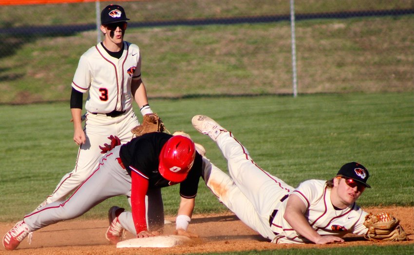 OZARK'S RHETT HAYWARD upends a Republic infielder as he steals second base in the teams' COC matchup Tuesday.