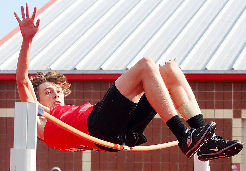 OZARK'S PEYTON LIGON looks to find his way over the high jump bar at the Ozark Relays on Tuesday.