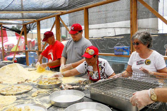 A group of hardworking volunteers prepare sucker fish for the Nixa Sucker Day Festival fish fry, 2010.