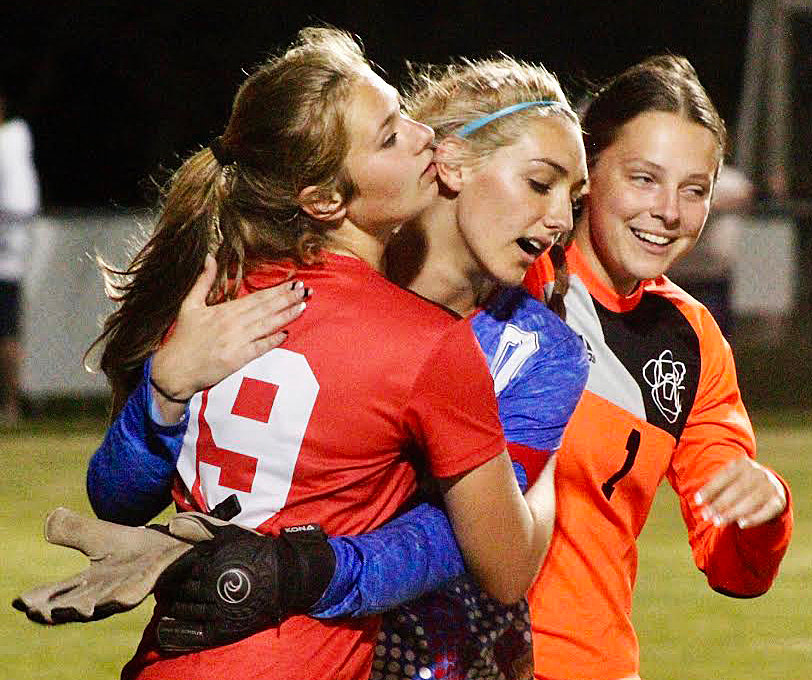 OZARK&rsquo;S LANEY BURKS receives congrats from teammates Audrey Carlton and Alexis Solomon following the Lady Tigers&rsquo; Class 4 District 5 semifinal win versus Nixa on Tuesday.