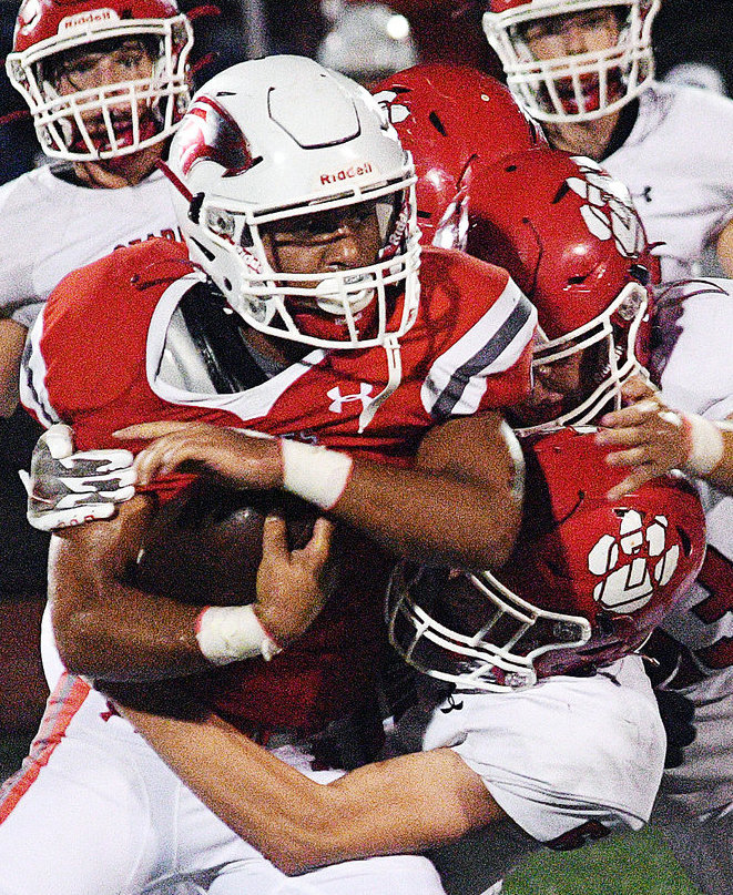 NIXA&rsquo;S SPENCER WARD tries to free himself from Ozark tacklers last season.