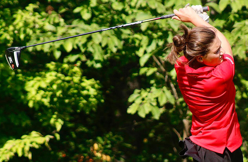 OZARK'S SAM COWEN follows through on her swing.
