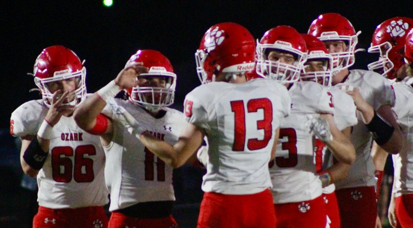 OZARK'S GARRETT BALLARD receives congrats from his teammates following one of his two touchdown catches Friday at Willard.