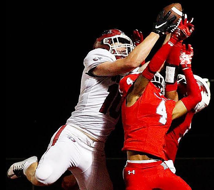 NIXA'S JORDAN TYLER AND SPENCER WARD battle with Joplin's Whit Hafer for possession of a pass Friday. Hafer caught the ball for a touchdown, but Nixa won 49-35.