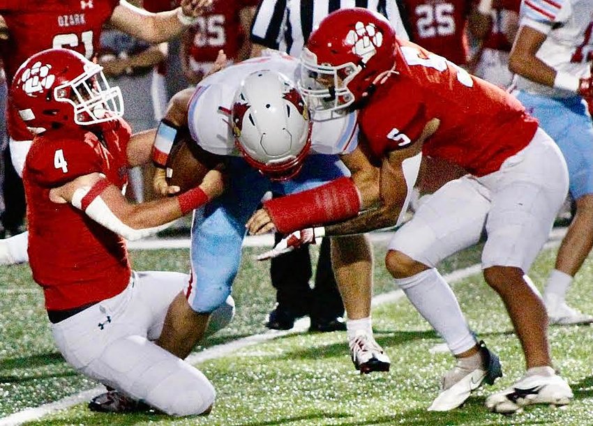 OZARK'S COOPER BUVID AND ELIJAH ORRIS team to tackle a Webb City ball-carrier Friday.
