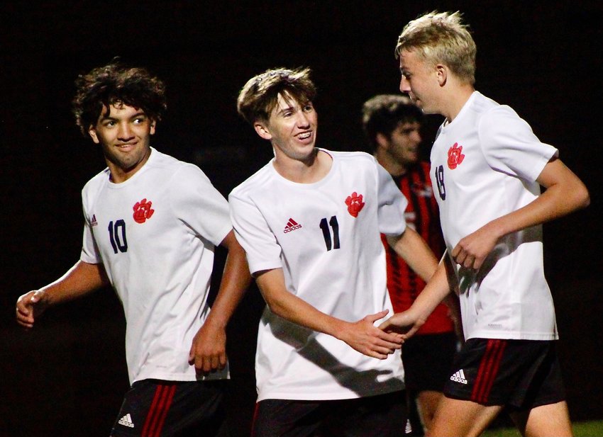 OZARK'S ZACH ULRICH, right, receives congrats from Adrian Ortega and Phin Scott after scoring Tuesday at Republic.
