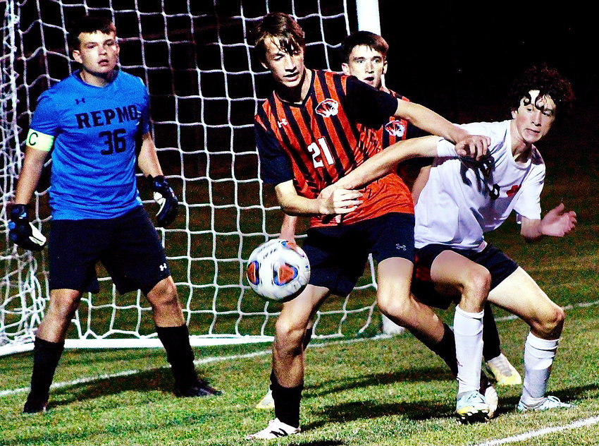 OZARK'S CALEB LEPANT fight for position in front of a loose ball at Republic last week.