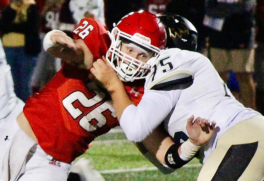 OZARK'S JACOB KRONEBUSCH works against a Neosho offensive lineman last week.