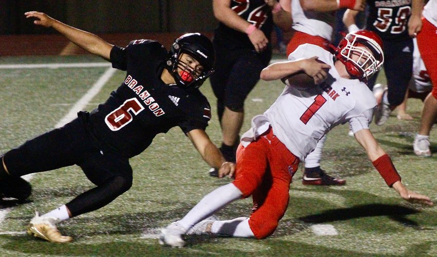OZARK'S BRADY DODD nears the goal line during the Tigers' 28-7 win at Branson on Friday.