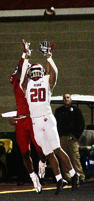 OZARK'S SAM CLARK gets set to reach for an interception in front of Nixa's Kael Combs on Friday.