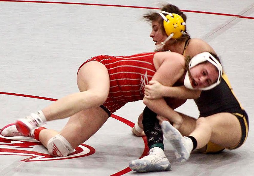 NIXA'S BRENYA CRAHAM tries to roll over Cassville's Faith James in the 135-pound final at the Nixa Invite on Monday.
