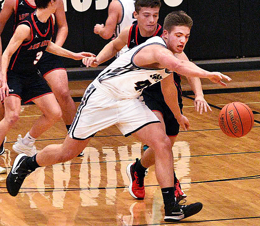 SPARTA'S DEXTER LOVELAND chases after a loose ball against Ash Grove on Tuesday.